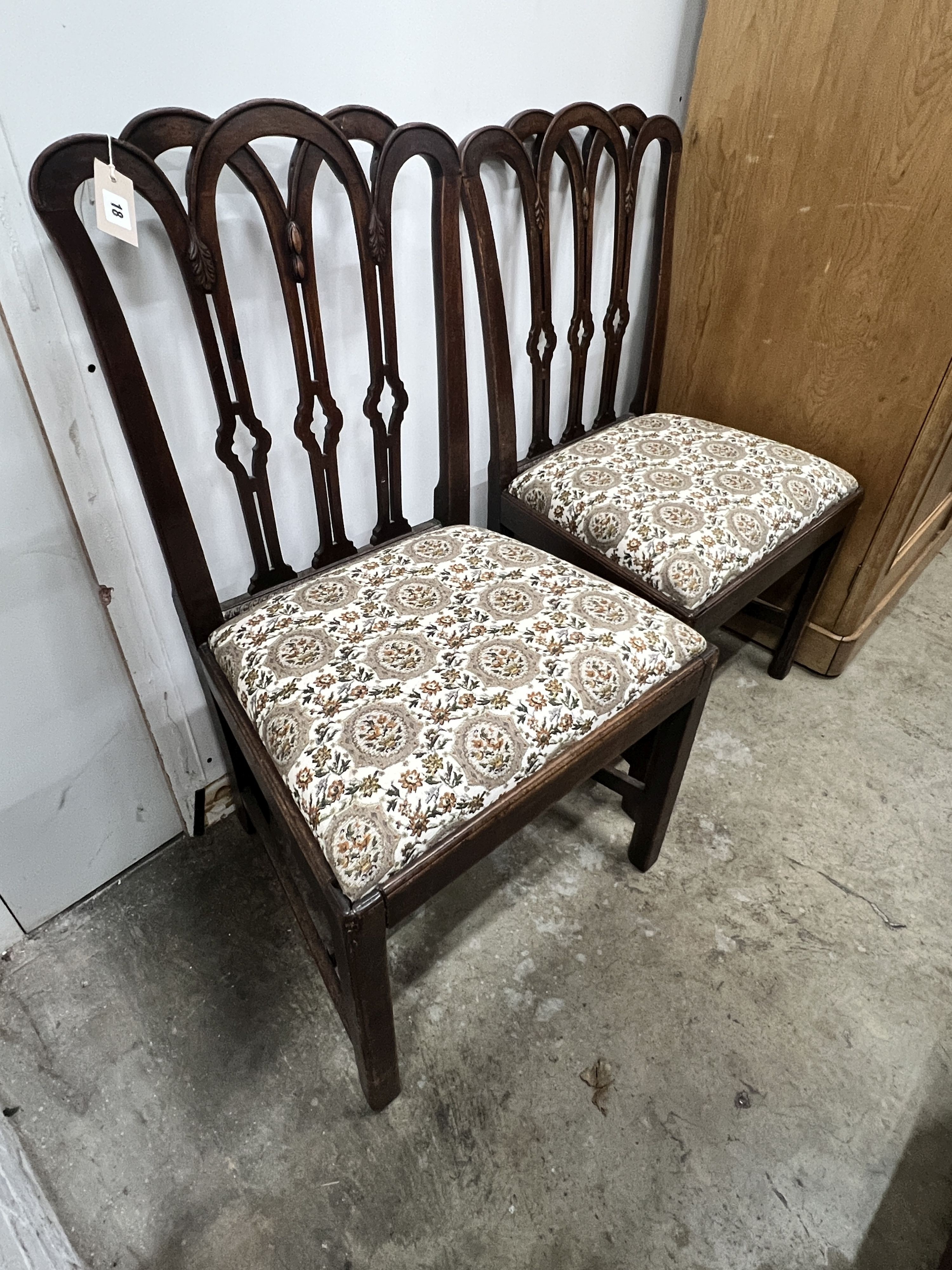 A pair of Georgian mahogany dining chairs, with pierced splats and drop-in seats on square legs